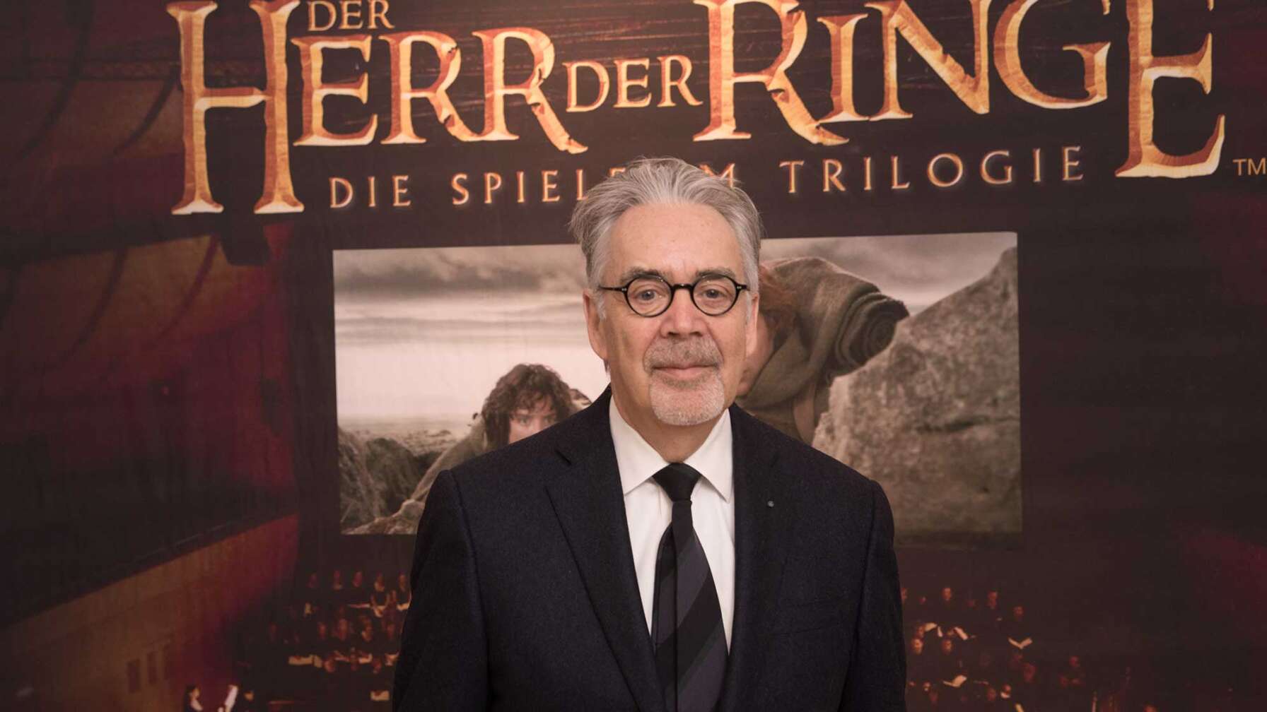 Der Komponist Howard Shore vor einem Plakat des Films "Der Herr der Ringe".