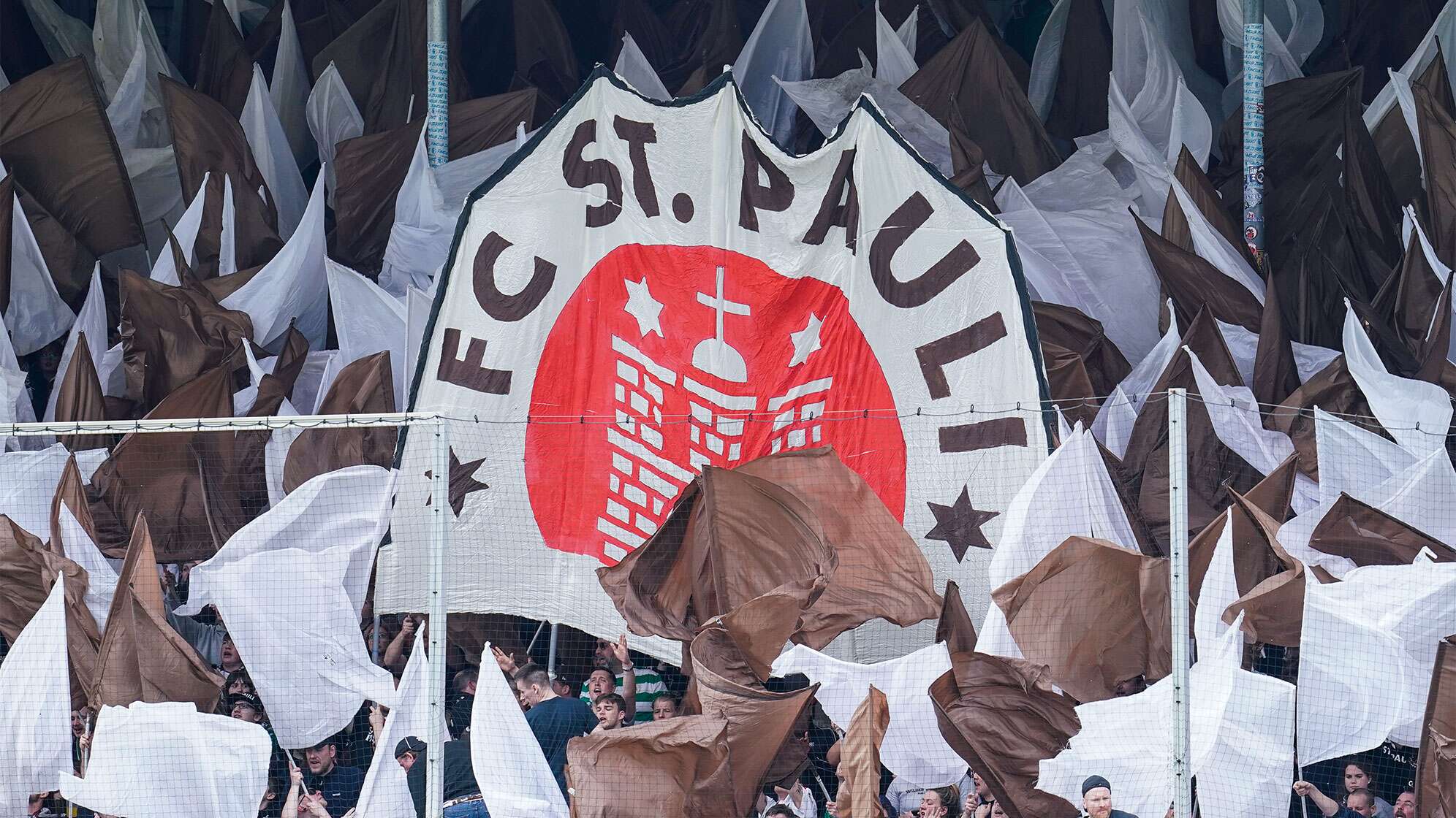 St. Paulis Fans halten im Fussballstadion ein Transparent mit der Aufschrift FC St. Pauli in die Höhe